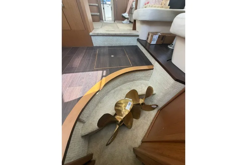 Slide: The Image of Interior of 2012 Carver 41 Cockpit Motor Yacht with propeller on carpeted floor. - 14