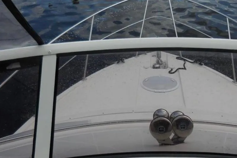 Slide: The Image of Front view of 2012 Carver 41 Cockpit Motor Yacht on water. - 4