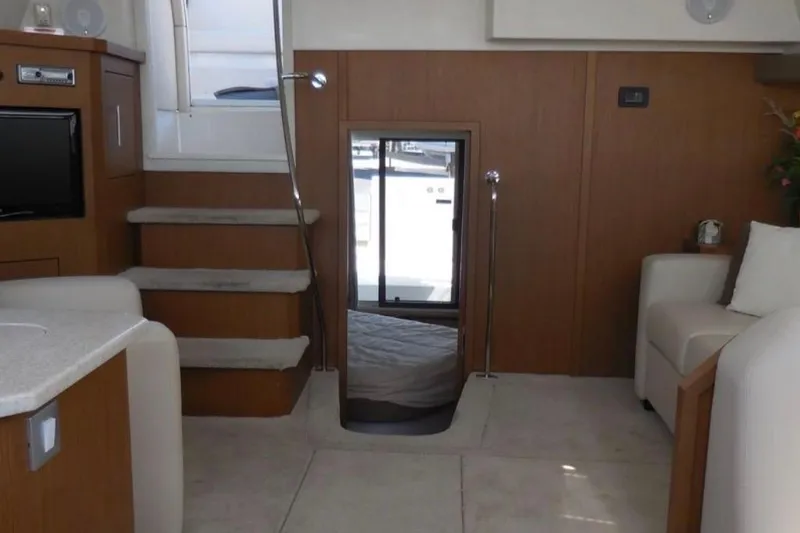 Slide: The Image of Interior of 2012 Carver 41 Cockpit Motor Yacht with stairs and cozy seating area. - 9