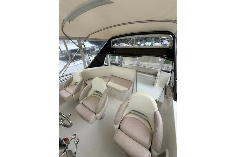 Slide: The Image of Interior of 2012 Carver 41 Cockpit Motor Yacht with plush seating and helm. - 13