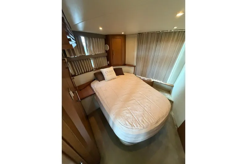 Slide: The Image of Interior of 2012 Carver 41 Cockpit Motor Yacht bedroom with cozy bed and pillows. - 33