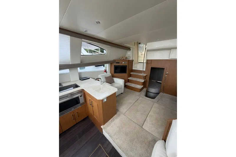 Slide: The Image of Interior of 2012 Carver 41 Cockpit Motor Yacht with modern kitchen and cozy seating area. - 37