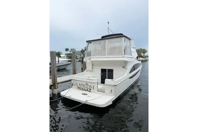 Slide: The Image of 2012 Carver 41 Cockpit Motor Yacht docked at marina, rear view. - 1