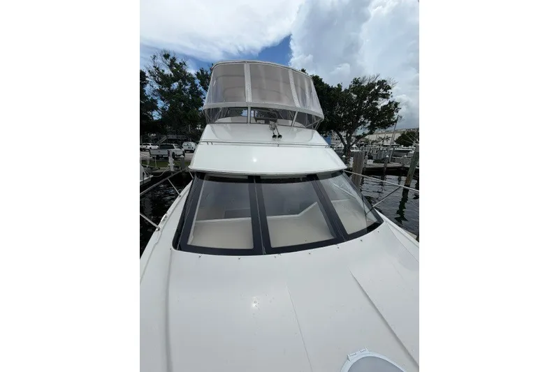 Slide: The Image of 2012 Carver 41 Cockpit Motor Yacht docked, featuring sleek design and spacious cockpit. - 38
