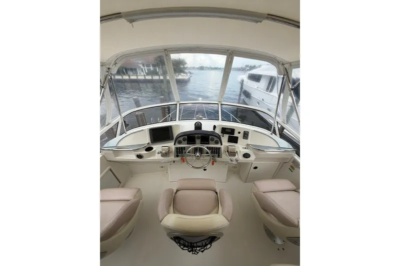 Slide: The Image of Interior view of 2012 Carver 41 Cockpit Motor Yacht helm with steering wheel and controls. - 14