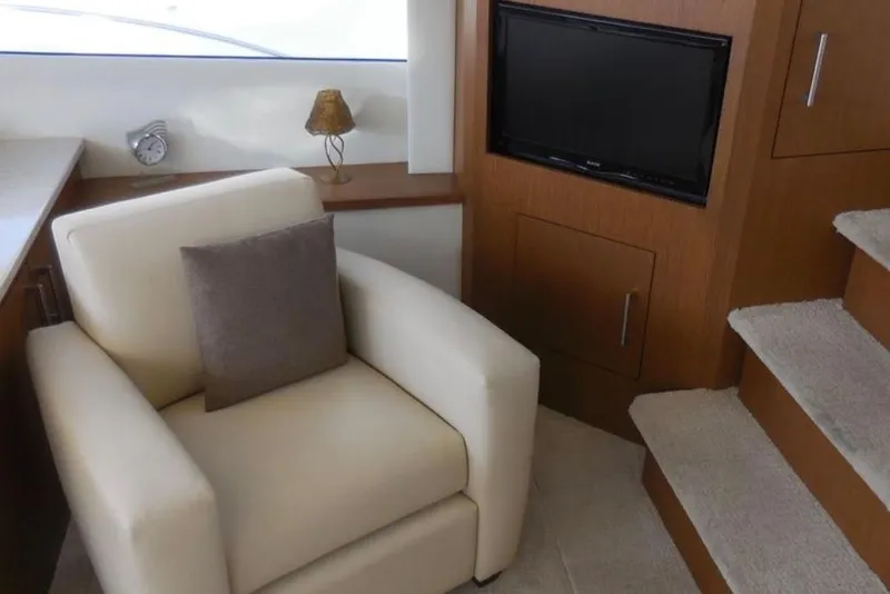 Slide: The Image of Luxurious interior of 2012 Carver 41 Cockpit Motor Yacht with armchair and TV. - 7