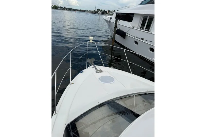 Slide: The Image of 2012 Carver 41 Cockpit Motor Yacht docked on calm water. - 5