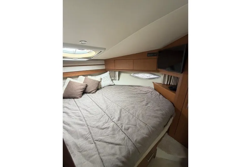 Slide: The Image of Luxurious bedroom interior of 2012 Carver 41 Cockpit Motor Yacht with cozy bedding. - 34