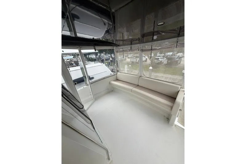 Slide: The Image of 2012 Carver 41 Cockpit Motor Yacht interior with spacious seating and panoramic windows. - 40