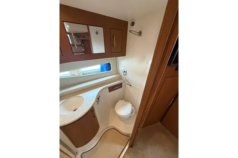Slide: The Image of Bathroom interior of 2012 Carver 41 Cockpit Motor Yacht, featuring sink and toilet. - 32