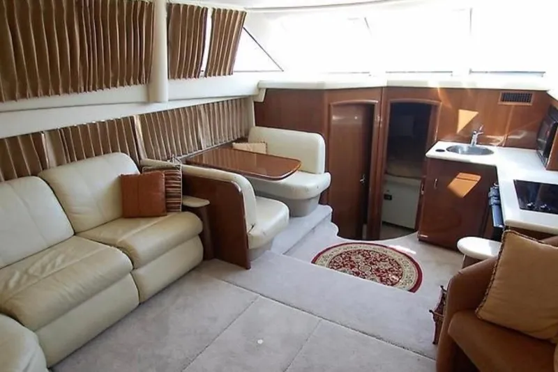 Slide: The Image of Luxurious interior of 2012 Carver 41 Cockpit Motor Yacht with plush seating and kitchenette. - 5