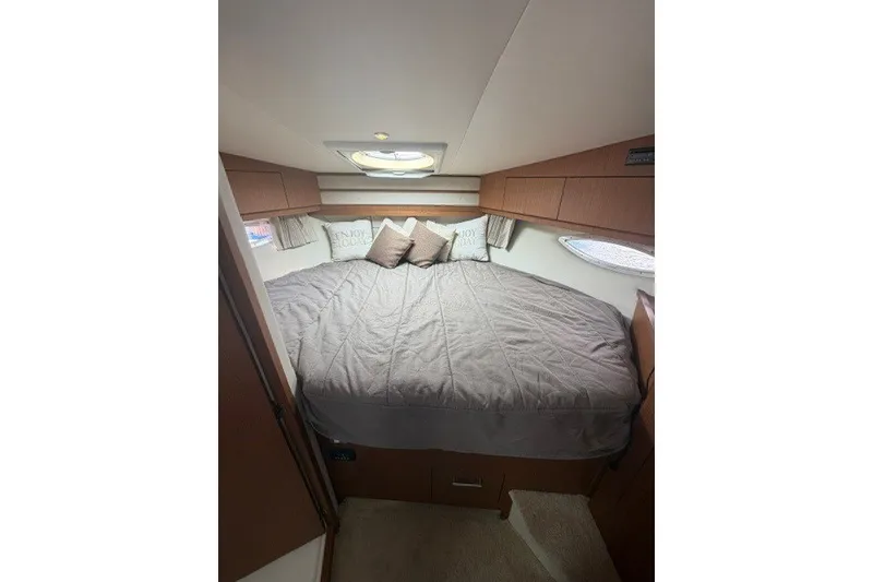 Slide: The Image of Luxurious bedroom interior of 2012 Carver 41 Cockpit Motor Yacht with cozy bedding. - 16