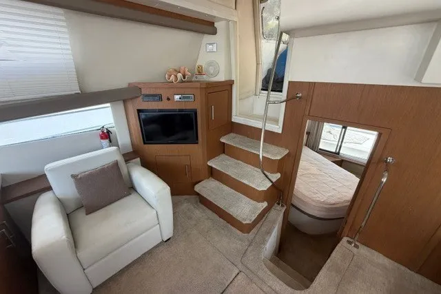 Slide: The Image of Interior of 2012 Carver 41 Cockpit Motor Yacht with cozy seating and modern amenities. - 6