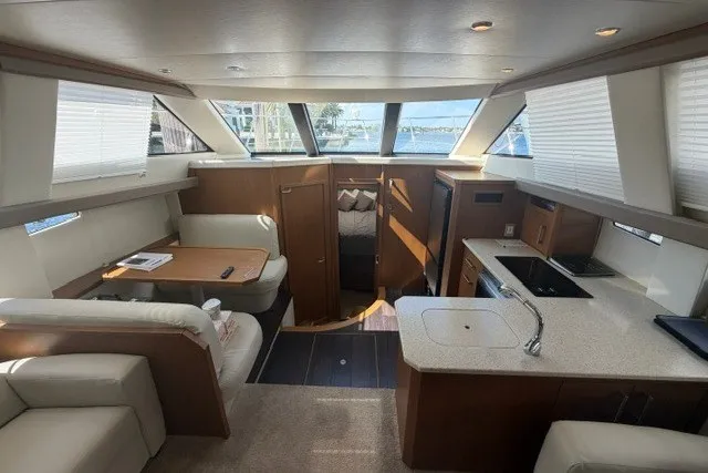 Slide: The Image of Luxurious interior of 2012 Carver 41 Cockpit Motor Yacht with modern kitchen and seating area. - 7