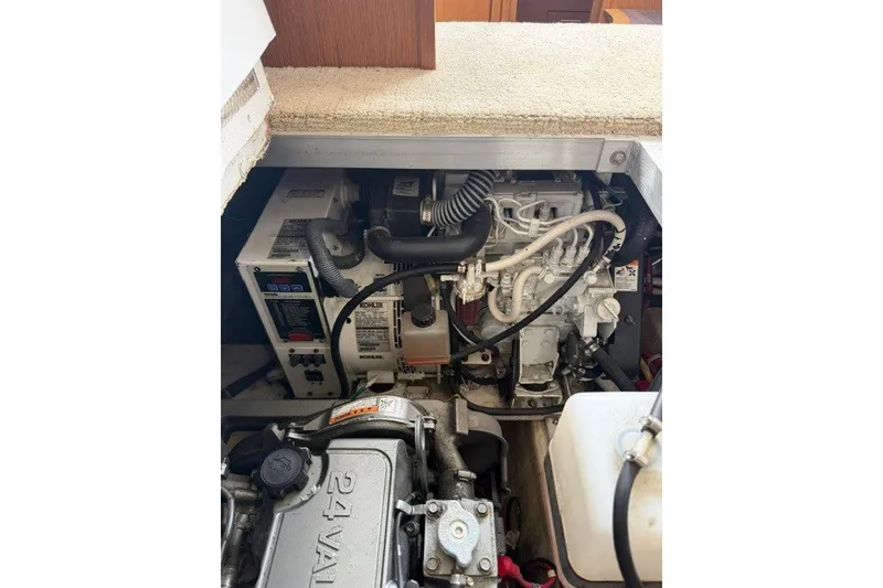 Slide: The Image of Engine compartment of a 2012 Carver 41 Cockpit Motor Yacht, showcasing mechanical components. - 41