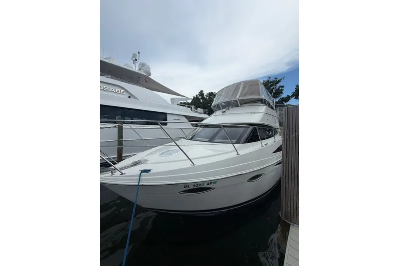 The Image of 2012 Carver 41 Cockpit Motor Yacht docked at marina, featuring sleek design and spacious cockpit. - 4