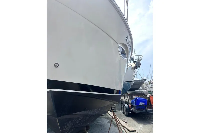 Slide: The Image of 2012 Carver 41 Cockpit Motor Yacht in dry dock, side view. - 3