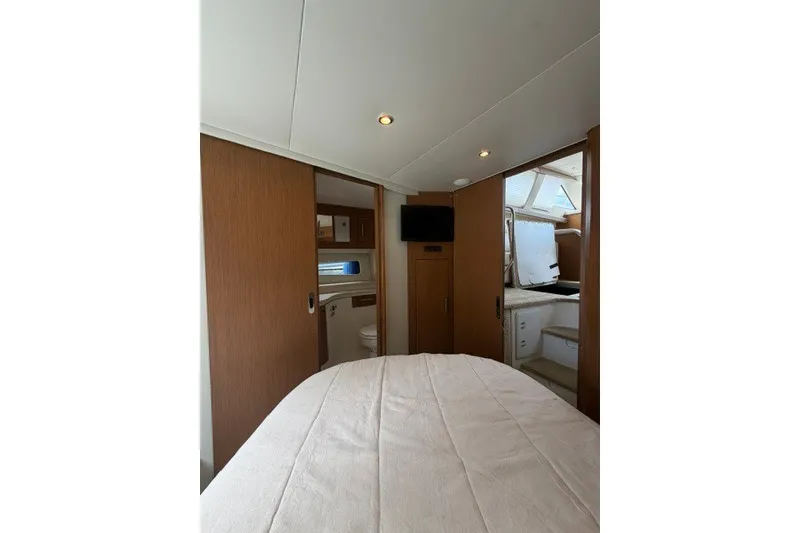 Slide: The Image of Interior of 2012 Carver 41 Cockpit Motor Yacht with cozy bedroom and modern amenities. - 31