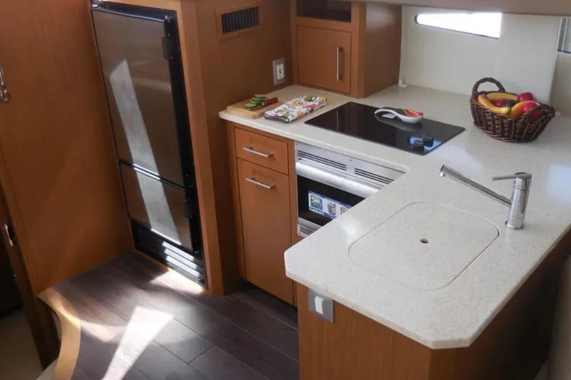 Slide: The Image of Modern kitchen in 2012 Carver 41 Cockpit Motor Yacht with sleek appliances and countertop. - 8