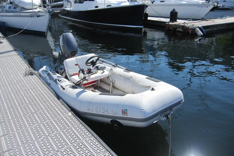 The Image of Inflatable Achilles 340 boat from 2002 docked at a marina. - 0