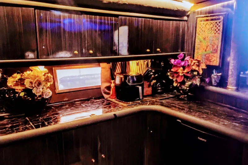 Slide: The Image of Luxurious interior of a 2000 Sunseeker Camargue 50 yacht with elegant decor and floral arrangements. - 24