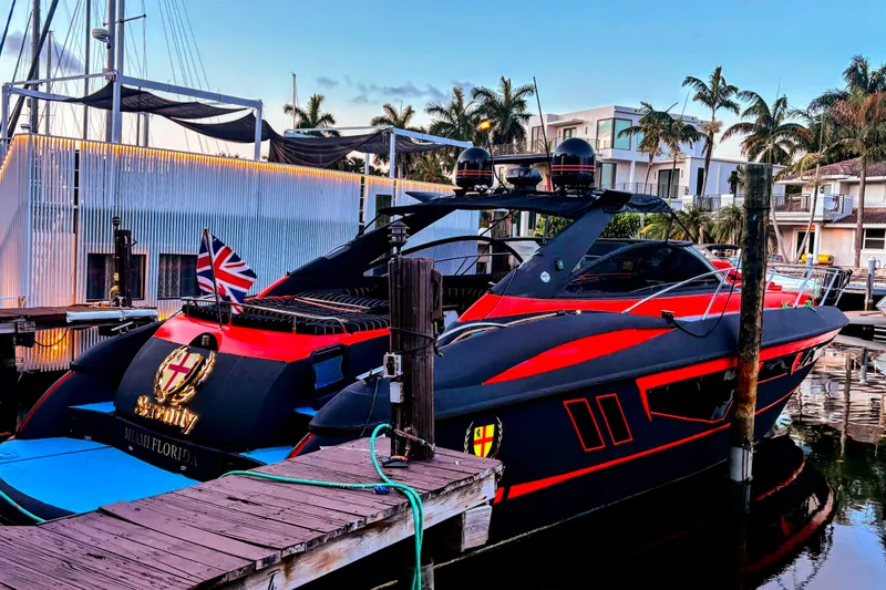 Slide: The Image of Sunseeker Camargue 50 yacht, 2000 model, docked in a marina with vibrant red accents. - 29