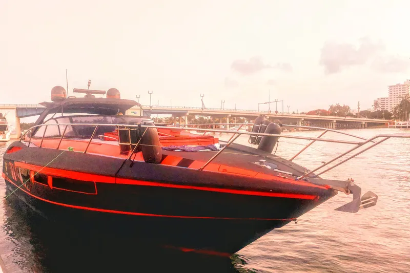 Slide: The Image of Sunseeker Camargue 50 yacht, 2000 model, docked by a scenic waterfront. - 8