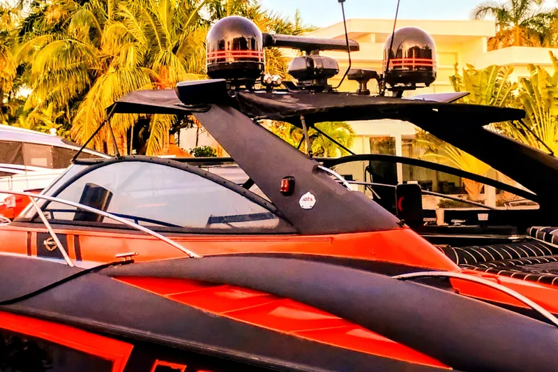 Slide: The Image of Red Sunseeker Camargue 50 yacht, 2000 model, docked with palm trees in the background. - 18