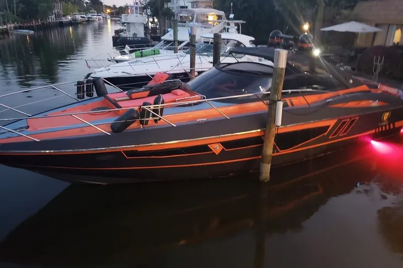Slide: The Image of Sunseeker Camargue 50 yacht docked at sunset, featuring sleek design and vibrant lighting. - 3