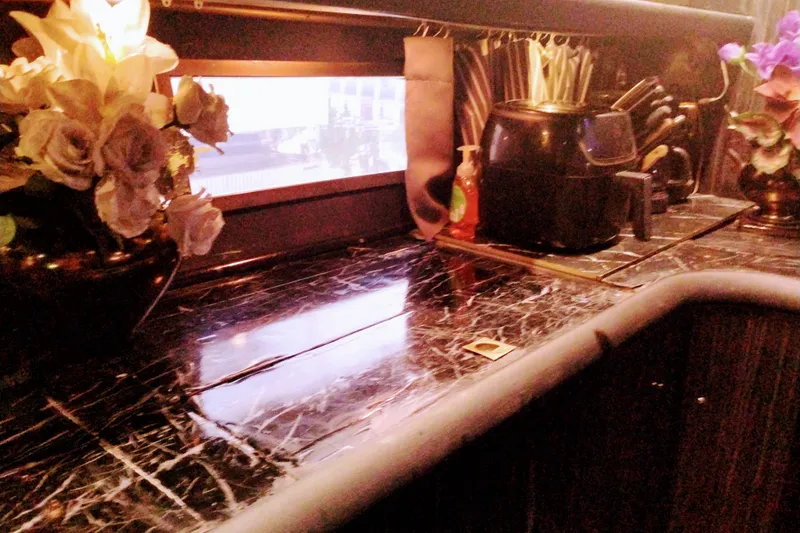 Slide: The Image of Luxurious Sunseeker Camargue 50 yacht interior with elegant marble countertop and floral decor. - 23