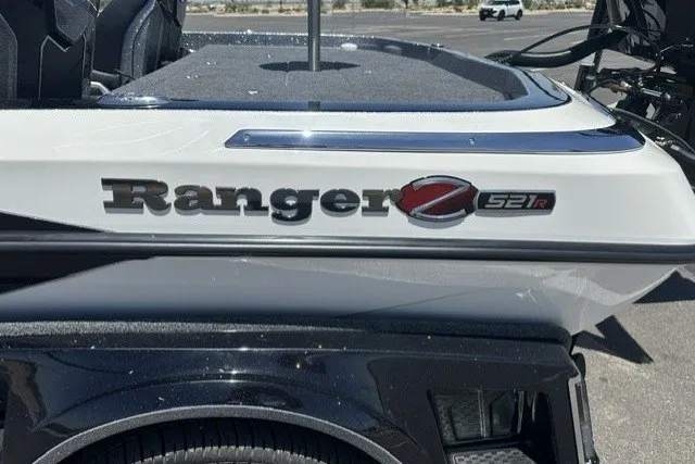 Slide: The Image of 2026 Ranger Z521R boat, sleek design with logo detail, parked outdoors. - 1