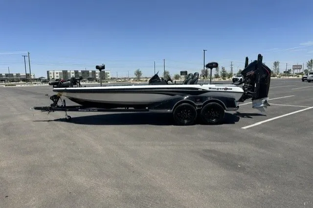The Image of 2026 Ranger Z521R boat on trailer in parking lot under clear sky. - 0