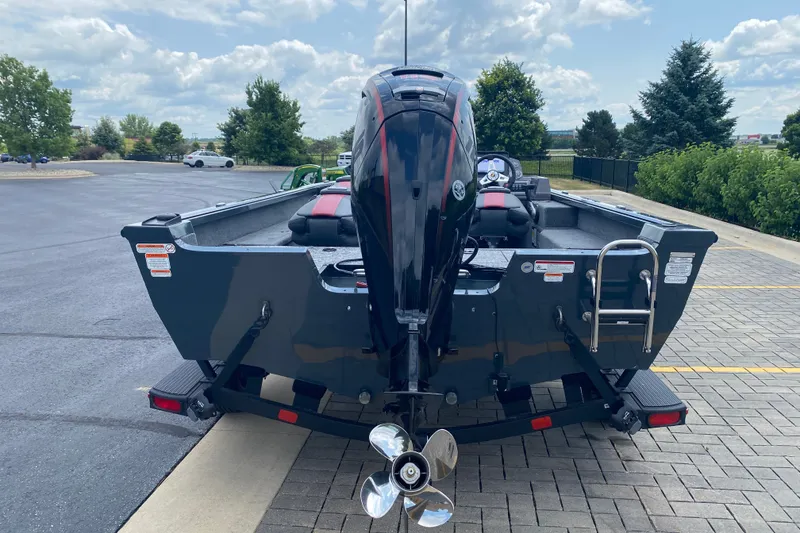 Slide: The Image of 2026 Ranger VS1782SC Angler boat with powerful outboard motor, parked on paved lot. - 2