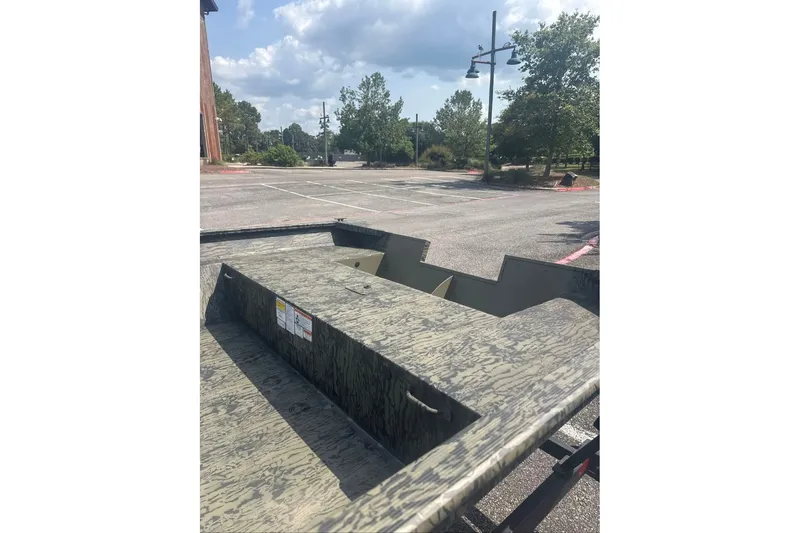 Slide: The Image of 2026 Tracker Grizzly 2072 Utility boat in a parking lot under a cloudy sky. - 6