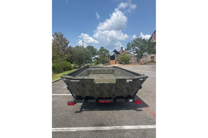 Slide: The Image of 2026 Tracker Grizzly 2072 Utility boat in parking lot under blue sky. - 3