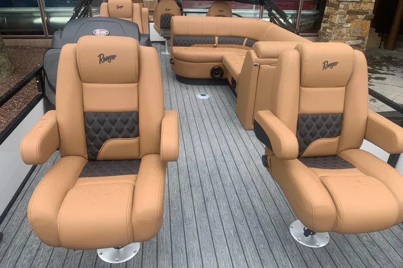 Slide: The Image of Luxurious 2026 Ranger 220F boat interior with tan leather seating and modern design. - 7