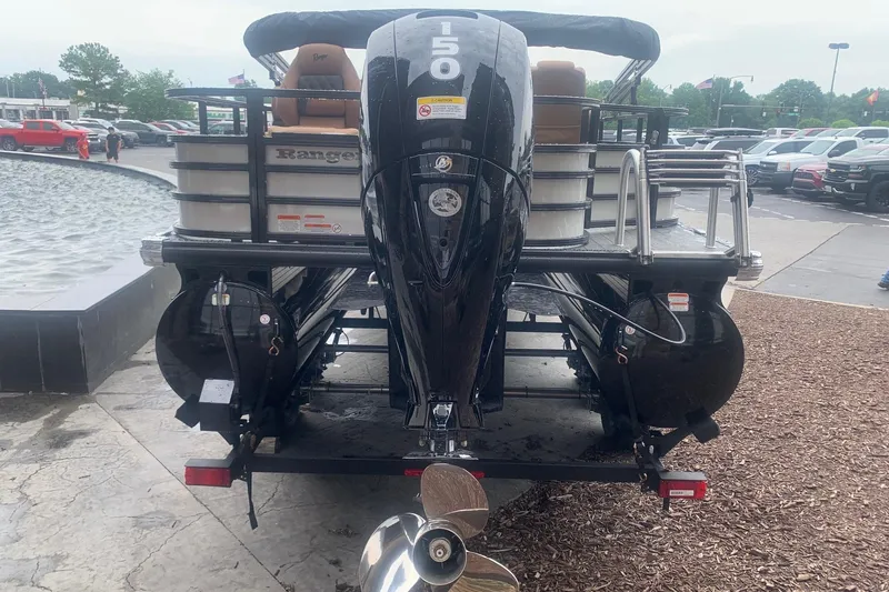 Slide: The Image of 2026 Ranger 220F boat with powerful outboard motor, parked near a fountain. - 3