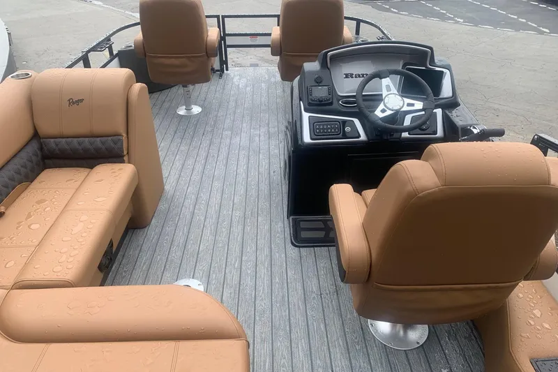 Slide: The Image of 2026 Ranger 220F boat interior with tan seating and modern steering console. - 10