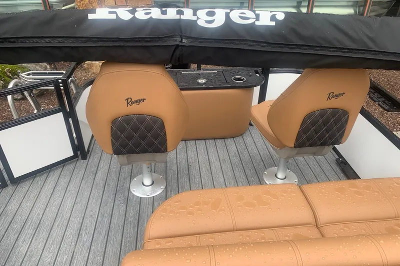 Slide: The Image of 2026 Ranger 220F boat interior with tan seats and black accents, featuring a sleek design. - 9