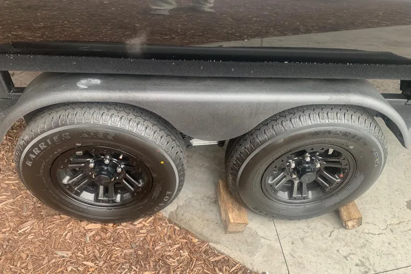 Slide: The Image of 2026 Ranger 220F trailer wheels on wooden blocks, featuring Karrier tires. - 6