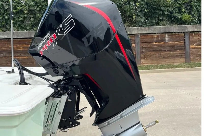 Slide: The Image of Mercury Pro XS engine on 2026 Mako 18 Pro Skiff, parked outdoors. - 4