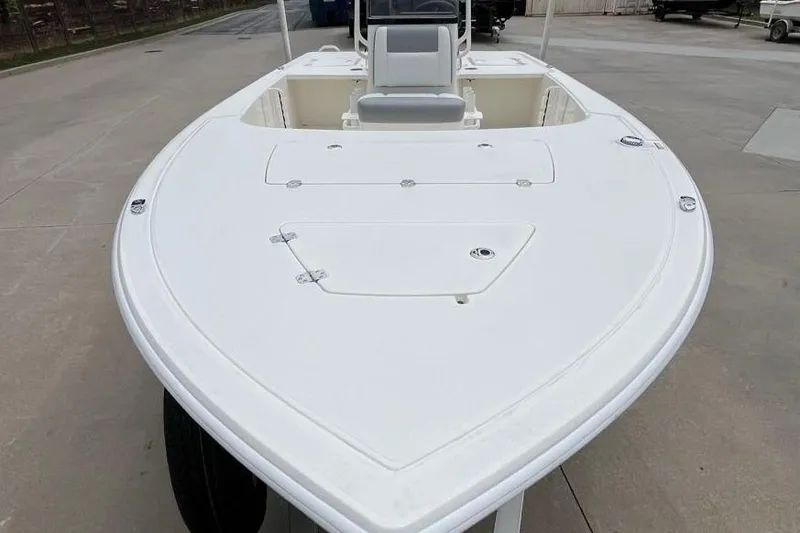 Slide: The Image of 2026 Mako 18 Pro Skiff boat with sleek white deck design. - 2