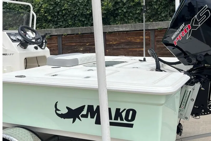 Slide: The Image of 2026 Mako 18 Pro Skiff boat with Mercury Pro XS engine, parked outdoors. - 3