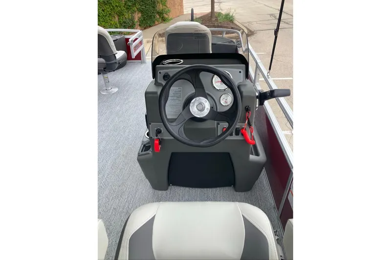 Slide: The Image of 2026 Sun Tracker Bass Buggy 18 DLX steering console with gauges and controls. - 4