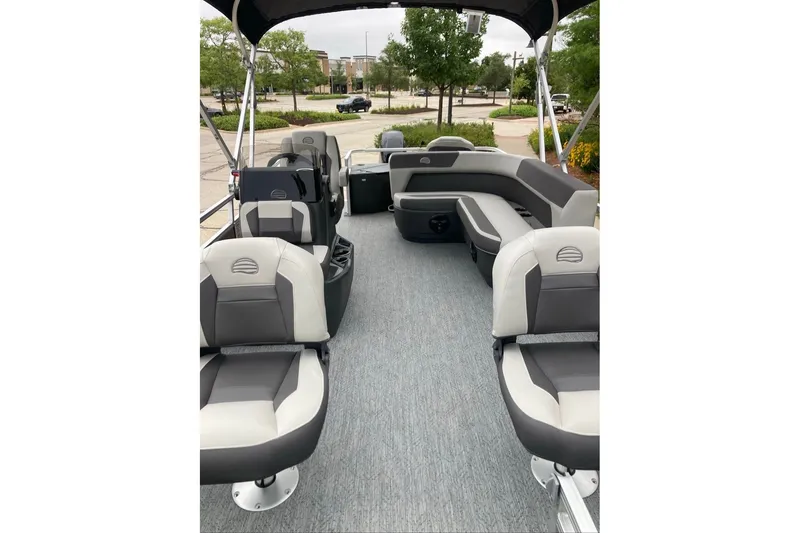 Slide: The Image of 2026 Sun Tracker Bass Buggy 18 DLX pontoon boat interior with seating and canopy. - 3