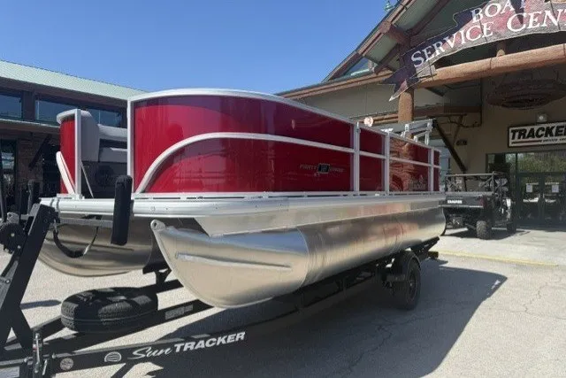 The Image of 2026 Sun Tracker Party Barge 18 DLX pontoon boat on trailer at service center. - 0