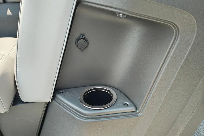 Slide: The Image of 2026 Sun Tracker Party Barge 24 XP3 interior cup holder and power outlet detail. - 13