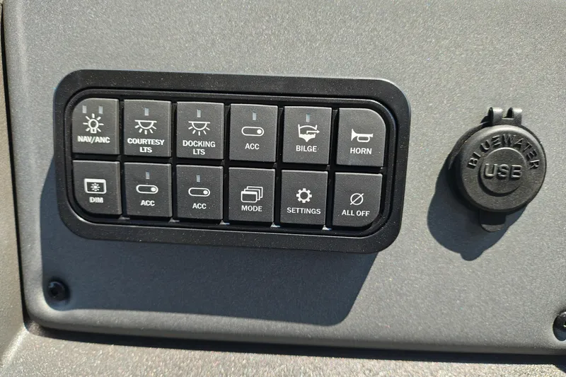 Slide: The Image of Control panel of 2026 Sun Tracker Party Barge 24 XP3 with USB port and various switches. - 18