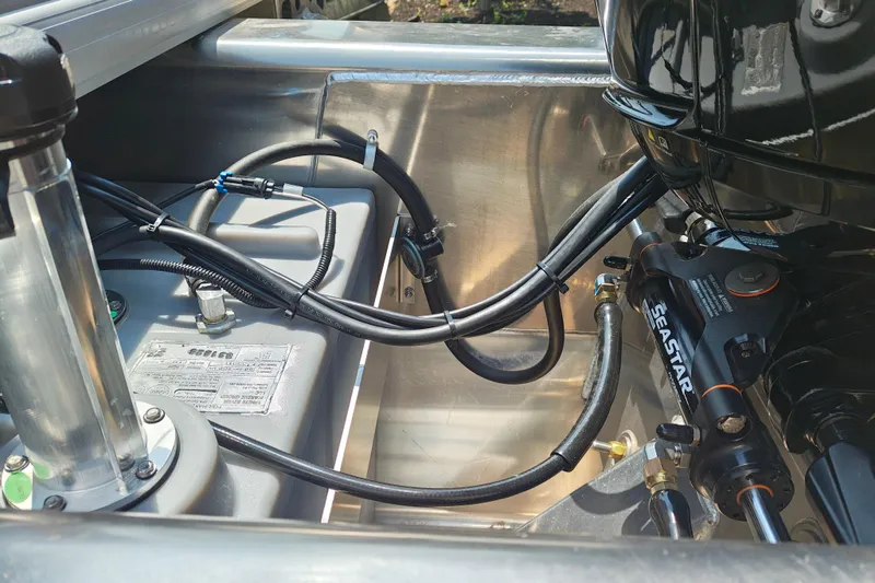 Slide: The Image of Close-up of 2026 Sun Tracker Party Barge 24 XP3 engine compartment with hydraulic components. - 6