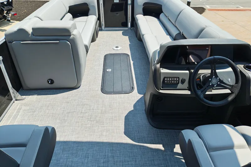 Slide: The Image of Interior of 2026 Sun Tracker Party Barge 24 XP3 with gray seating and steering console. - 30